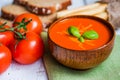 Tomatoe soup with bread sticks and basil on wooden background Royalty Free Stock Photo