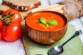Tomatoe soup with bread sticks and basil on wooden background Royalty Free Stock Photo
