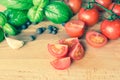 Tomatoes basil garlic and allspice on the wooden table Royalty Free Stock Photo