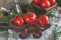 Tomatoes on a beautiful old metal plate with a thyme with a knife and scissors on a wooden table in a rustic style. Royalty Free Stock Photo