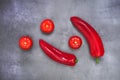 tomatoes and bell peppers over a concrete surface