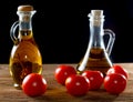 Tomatoes and bottles of olive oil on table Royalty Free Stock Photo