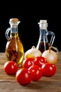 Tomatoes and bottles of olive oil on table Royalty Free Stock Photo