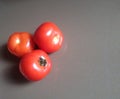 Tomatoes on brown background.