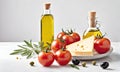 Tomatoes, cheese, olives and glass bottles with oil on a white table. Food still life of cheese with tomatoes and olives on a Royalty Free Stock Photo