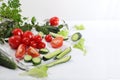 Tomatoes, cucumbers and parsley for cooking salad, Fresh summer vegetables on a bright sunny table with place for text, detox diet Royalty Free Stock Photo