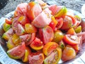 Tomatoes are cut and placed in a plate