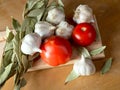 Tomatoes garlic and a bay leaf Royalty Free Stock Photo