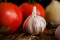 Garlic and tomatoes on a wood background close-up ingredients table top Royalty Free Stock Photo