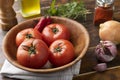 Tomatoes, garlic, peppers and herbs over wood table Royalty Free Stock Photo