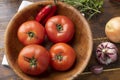 Tomatoes, garlic, peppers and herbs over wood table Royalty Free Stock Photo