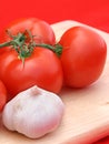 Tomatoes & Garlic on Red Royalty Free Stock Photo
