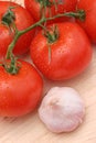 Tomatoes & Garlic on Wood Royalty Free Stock Photo