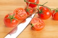 Tomatoes and kitchen knife blade Royalty Free Stock Photo