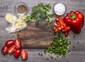 Tomatoes, leek parsley and dill chopped red pepper green onion on a wooden cutting board wooden background top view Royalty Free Stock Photo