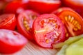 Tomatoes macro, red healthy vegetable sliced on wooden desk. Macro detail of red fresh tomato from garden. Royalty Free Stock Photo