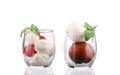 Tomatoes and mozzarella balls in glass.