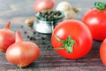 Tomatoes, onions, garlic and black pepper on wooden background. Close up Royalty Free Stock Photo