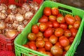 Tomatoes and onions on plastic box