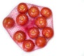 Tomatoes packaged in red plastic net Royalty Free Stock Photo