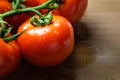 Tomatoes panicles on a wooden chopping board