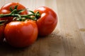 Tomatoes panicles on a wooden chopping board