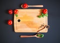 Tomatoes, pepper and green basil leaves on wooden cutting board Royalty Free Stock Photo