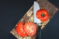 Tomatoes are prepared for blanching. Knife lay next to cuttable tomato