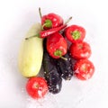 Tomatoes, red sweet peppers, red hot chilli peppers, violet eggplants, green zucchini in drops of water Royalty Free Stock Photo