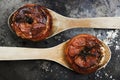 Tomatoes with rice with wooden spoons on metal plate