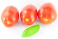 Tomatoes (roma - solanum lycopersicum) with green leaf