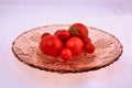 Tomatoes on rose glass fruit bowl Royalty Free Stock Photo