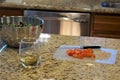 Tomatoes, salad and glass of Grammies` wine on counter