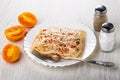 Tomatoes, salt shaker, pepper shaker, chicken aspic in plate, fork on table