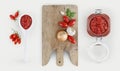 Tomatoes sauce with wooden cutting board, onion,, basil, garlic. Royalty Free Stock Photo