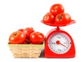 Tomatoes on scales and in a basket. Royalty Free Stock Photo