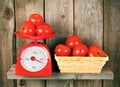 Tomatoes on scales and in a basket Royalty Free Stock Photo