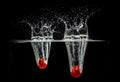 Tomatoes Splash Photography: on a black background Royalty Free Stock Photo