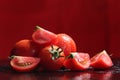 Tomatoes under water drops, red background Royalty Free Stock Photo