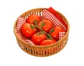 Tomatoes in wattled basket isolated on white Royalty Free Stock Photo