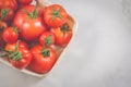 Tomatoes in a wattled basket/tomatoes in a wattled basket on a white background. Top view and copyspace