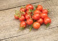 Tomatoes on wooden background, cherry variety. Tomato benefits Royalty Free Stock Photo