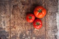 Tomatoes on wooden background,top view