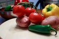 Tomatos peppers and red pototoes on a cutting board