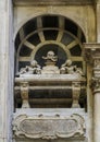 Tomb with latin inscription and skulls on top inside the Genoa Cathedral