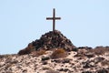 A tomb with a pile of stones and a wooden cross Royalty Free Stock Photo