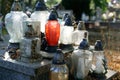 A tombstone with many burned and dirty candles standing on it