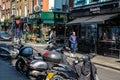 Tommi\'s Burger Joint And Toi & Moi Cafe with motor Scooters Parked In A Line