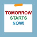 tomorrow starts now post it on blue Royalty Free Stock Photo
