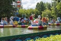 Tomsk, Russia - July 20, 2021 - Children`s boats in the form of Swans and a crocodile, in a park pond.